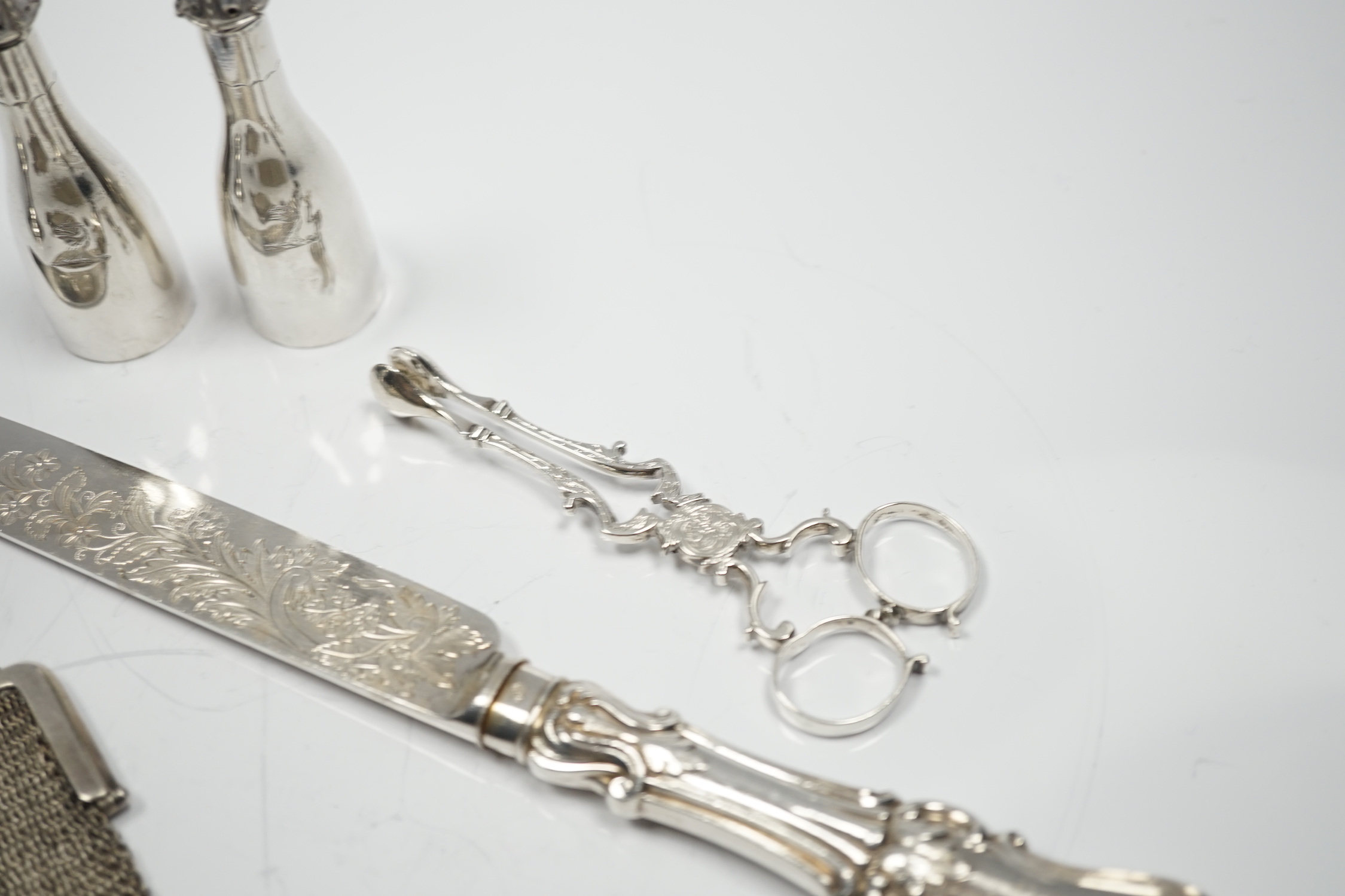 A George III silver inverted pear shaped cream jug, with later embossed decoration, London, 1774, a pair of late Victorian bottle shaped pepperettes and other small silver.